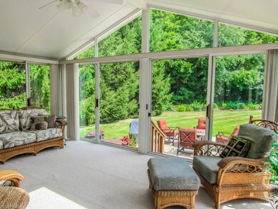 The gorgeous sunroom has vaulted ceilings and spec