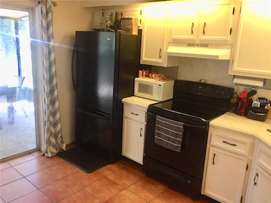 KITCHEN. VIEW TOWARD SLIDERS TO SCREENED PORCH