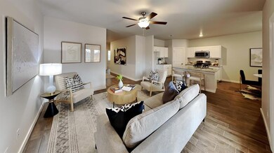 Living area featuring a ceiling fan and light wood-style floors