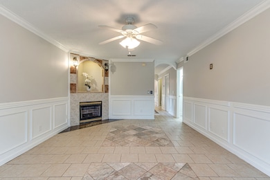 Another view of the living room with a tile surround on the fireplace.  Half bath directly off the living room and kitchen.
