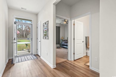 Foyer entrance featuring visible vents, baseboards