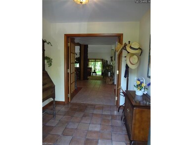 The foyer invites you in through beveled glass doo