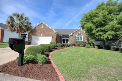 Ranch-style house featuring concrete driveway, bri
