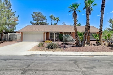 View of front of home featuring a tile roof, a gar