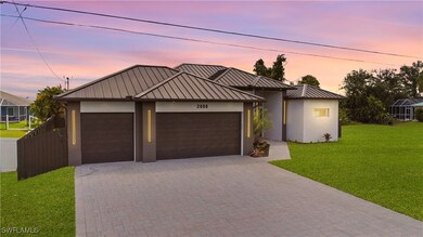 View of front facade featuring a lawn, a garage, a