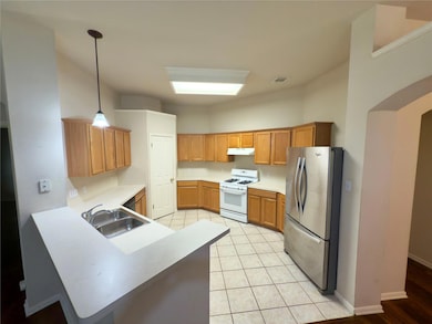 Kitchen featuring freestanding refrigerator, whit