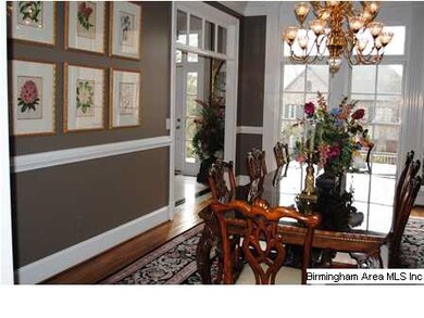 The dining room has large windows, transoms over t