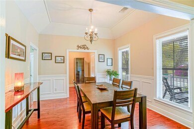 Formal dining room with wainscoting, elegant light