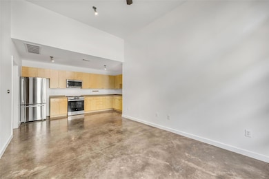 Kitchen with finished concrete floors, visible ve