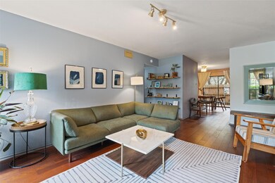Living area featuring wood-type flooring and rail