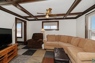 Living area with ceiling fan, plenty of natural li