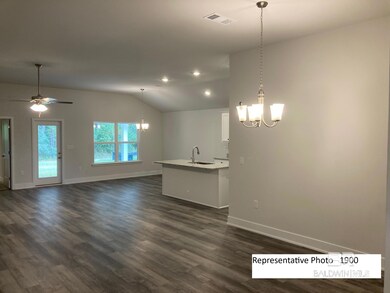 Kitchen with a chandelier, white cabinets, vaulted ceiling, decorative light fixtures, and open floor plan