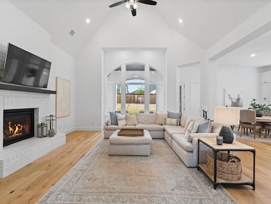 Living room with a painted brick fireplace, oak ha