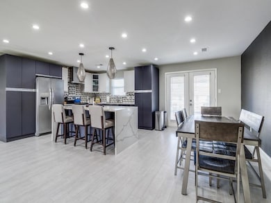 Kitchen featuring stainless steel fridge, light wo