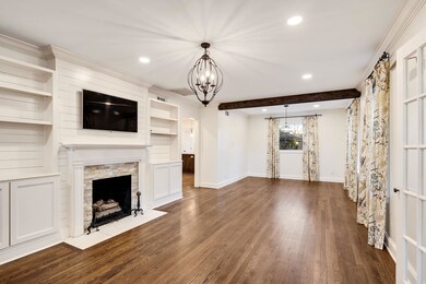 Unfurnished living room with a chandelier, beamed 