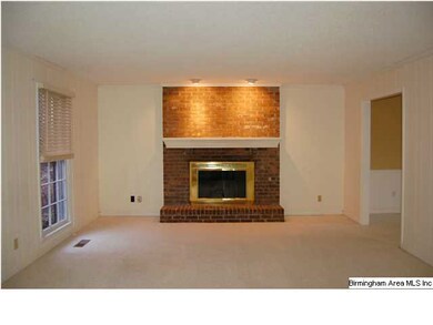 The spacious living area has a beautiful brick, wo