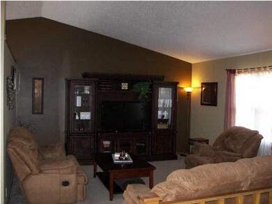 The living room is spacious with vaulted celings a