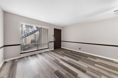 Empty room featuring hardwood / wood-style floorin