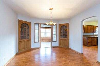 Dining room with open door to 3 season room