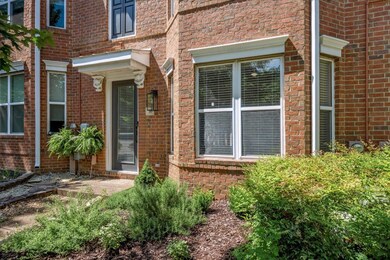 Doorway to property featuring brick siding