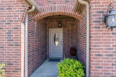 Freshly painted front door welcomes your guests.  Notice the upgraded carriage lighting on the garage and porch.