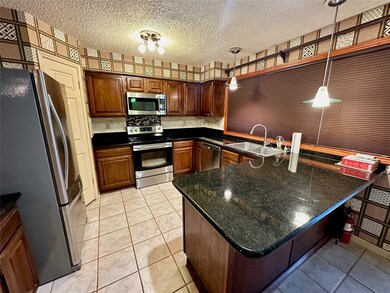 Spacious kitchen with large granite countertops