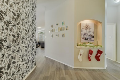 Hall featuring wood finished floors and a high ce