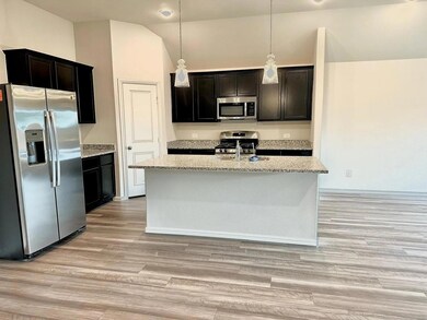 Kitchen featuring light stone countertops, a kitch