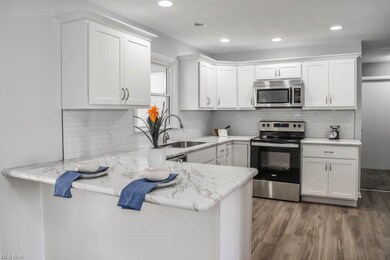 Brand new kitchen with white cabinets and a breakf