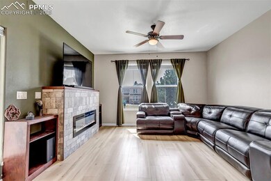 Living room with a fireplace, light wood-style flo