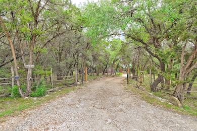 View of road featuring a gated entry and gravel d
