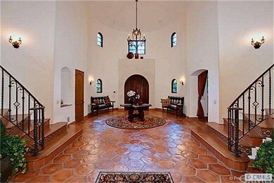 Elegant Spanish Foyer with Double Staircase