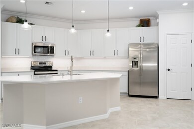 Kitchen with stainless steel appliances, a sink, v