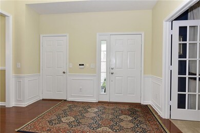 Look at this huge entry! Fresh paint beautiful wainscoting! Hardwood floors. Classic! Nine foot ceilings.