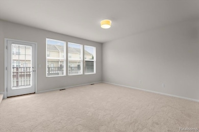 Carpeted empty room with baseboards