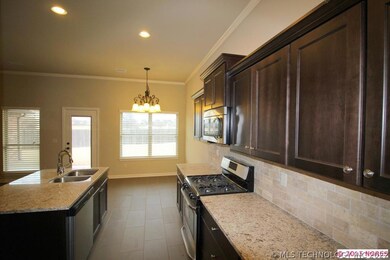 Kitchen includes granite counters and island