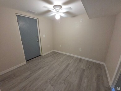 Spare room with finished floors and a ceiling fan