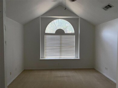 Carpeted spare room featuring lofted ceiling