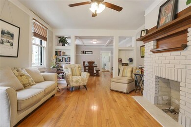 Living room with built-in shelves, hardwood floors