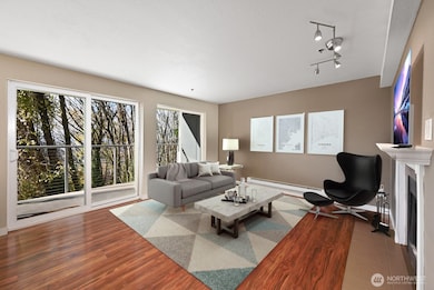 With warm, wood laminate flooring and a glass door to a private deck. (virtually staged)