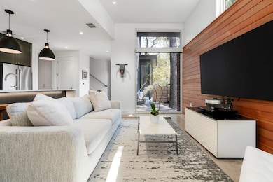 The living room offers tall ceilings, abundant natural light, and effortless flow for entertaining and daily living.