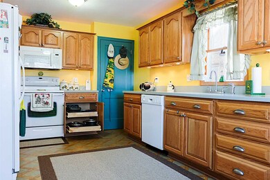 Pull-out shelves in all cabinets. The door leads t