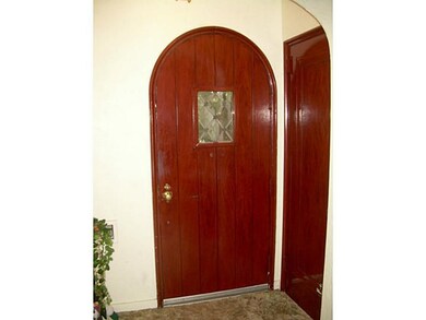 Entry/Foyer. Arched front door and coat closet in 