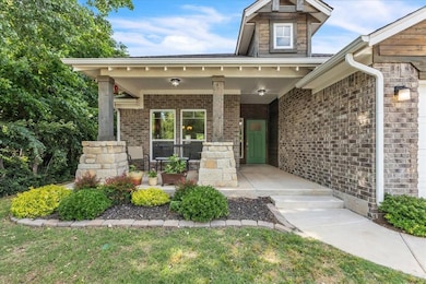 Property entrance with a porch and brick siding
