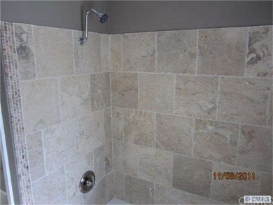 Remodeled bathroom with new tub and stone walls
