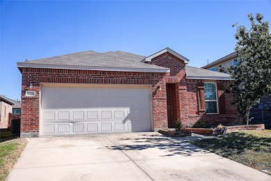 Ranch-style house featuring brick siding, a shingled roof, driveway, and a garage