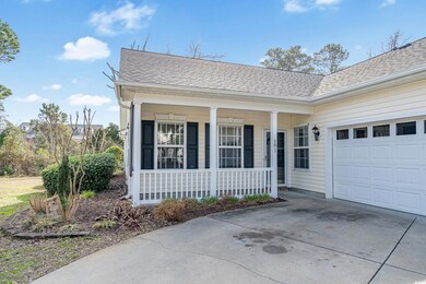 View of front of house featuring a garage and a po