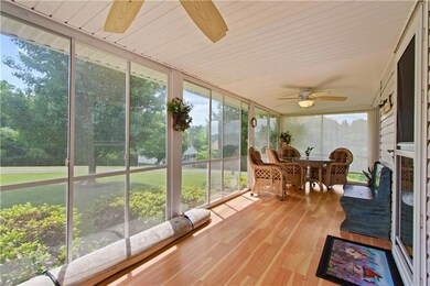 Sunroom featuring a ceiling fan