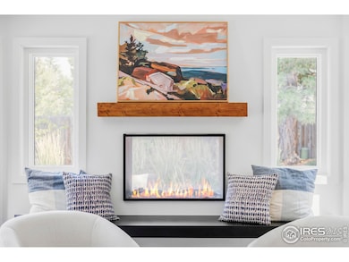 The family room impresses with wraparound windows, exposed wood beams, and a double-sided fireplace that connects to the backyard patio.