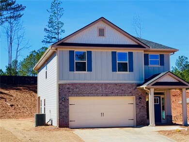 View of front of home with a garage, brick siding, driveway, and board and batten siding